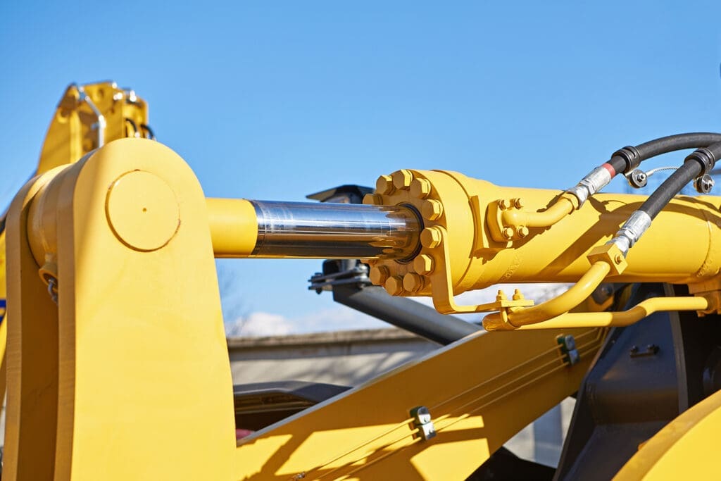 Hydraulic cylinder and piston assembly on construction equipment